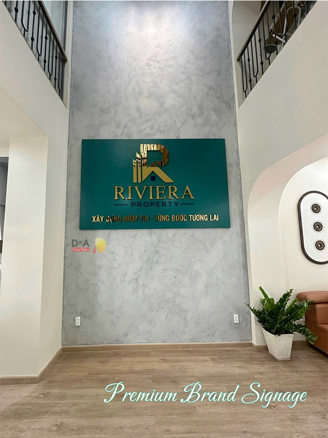 Logo inox vàng gương Riviera, thi công logo công ty cao cấp bởi Nhật Thiên D&A